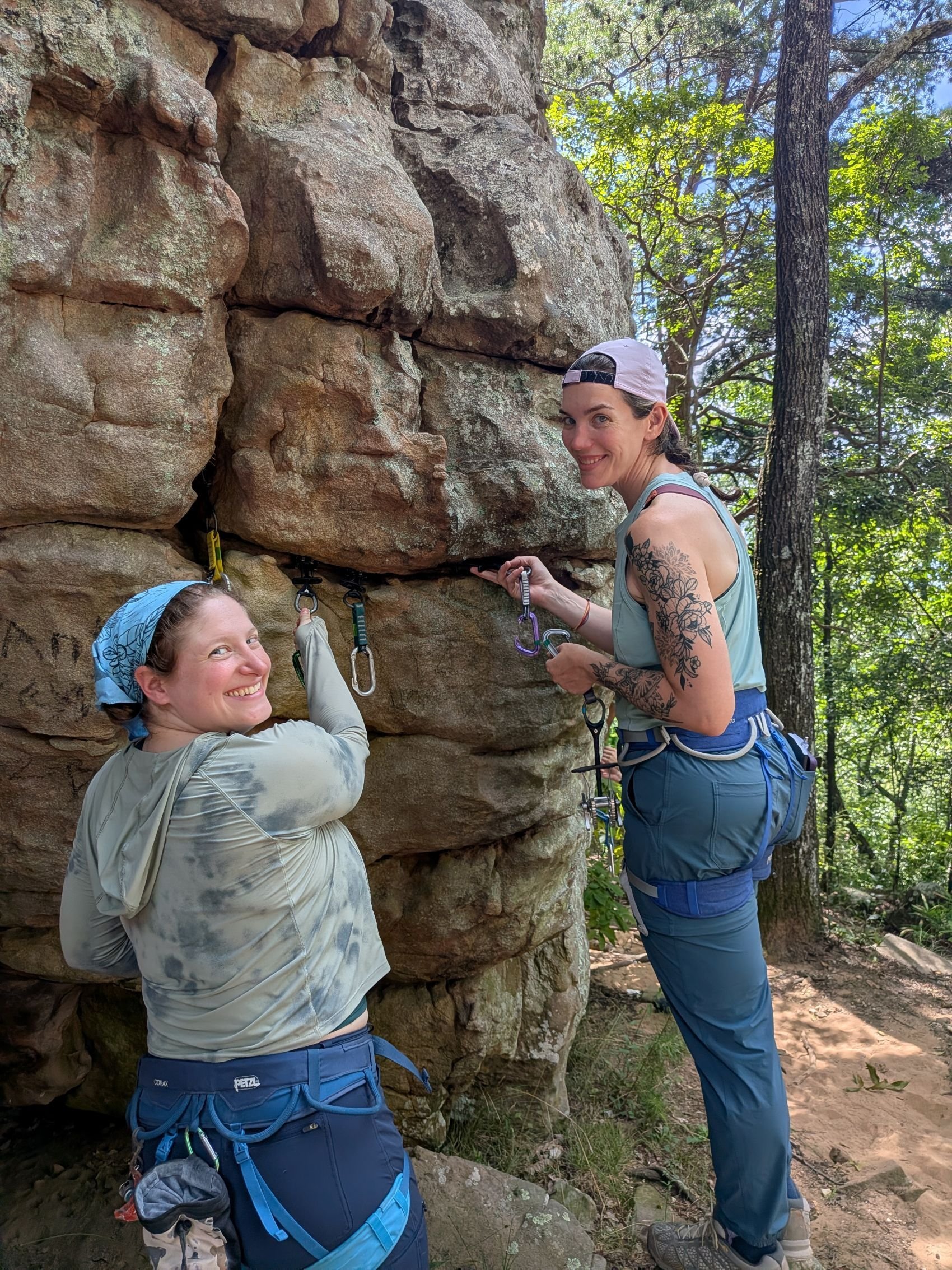 Women placing traditional gear in the rock.